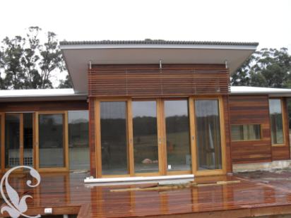 Custom timber bi-fold doors and feature windows on a Maryborough home